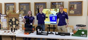 Three members of REMADE pose for a picture at Open House