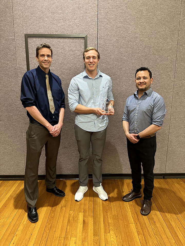 Cal Dunekack recieving his award from two professors