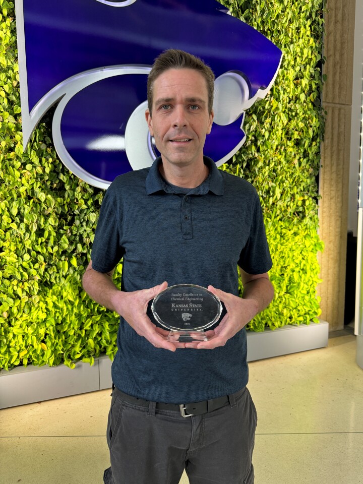 Ryan Hansen poses with award