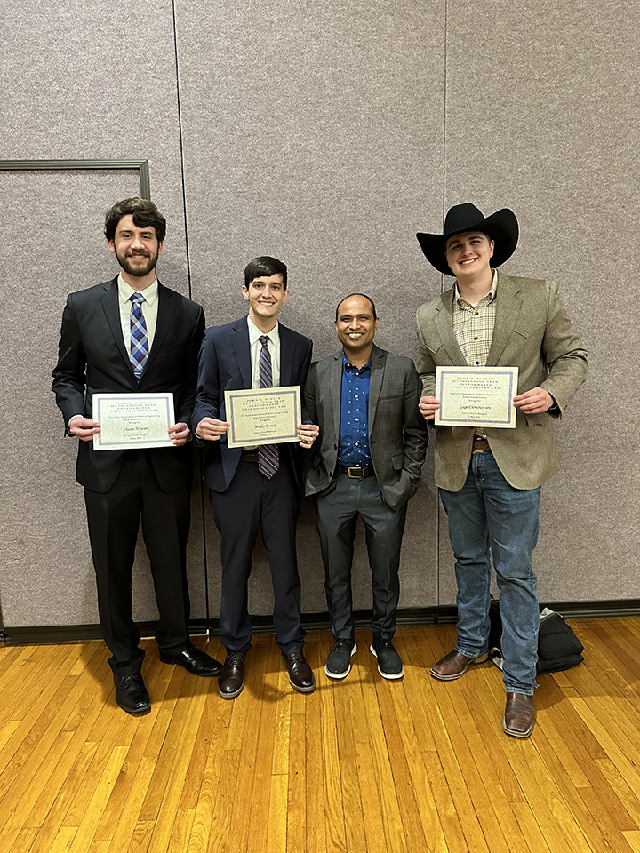 Shaun Houser, Brady Daniel, Helal Uddin, Gage Christiansen receive their award