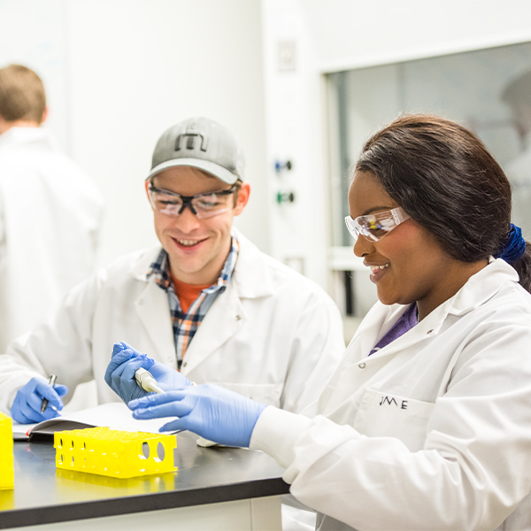 Two students work in a lab.
